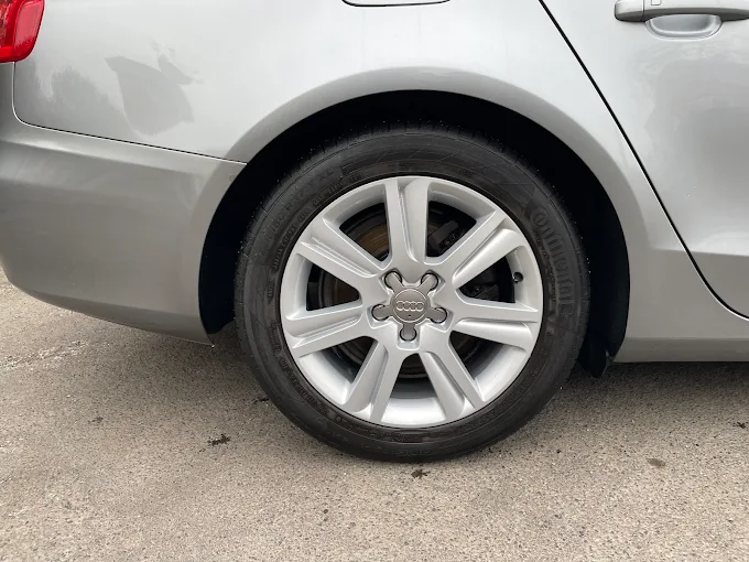 Silver Audi alloy wheel fitted to a grey car
